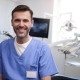 Portrait of smiling dentist in dentist's office